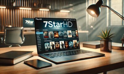 A modern workspace with a laptop displaying the 7starhd website, showcasing HD movie download options.